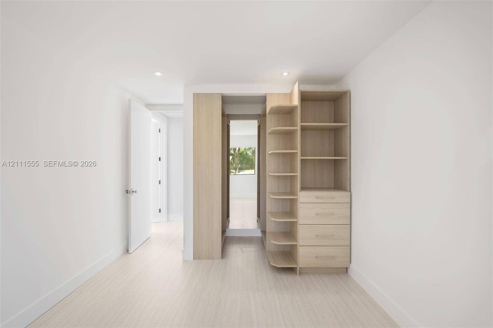 8800 SW 118th Street, Miami, Miami, FL 33176 Custom built-in wood-finish cabinetry featuring open shelving and four integrated drawers, recessed ceiling lighting, and wood-finish flooring