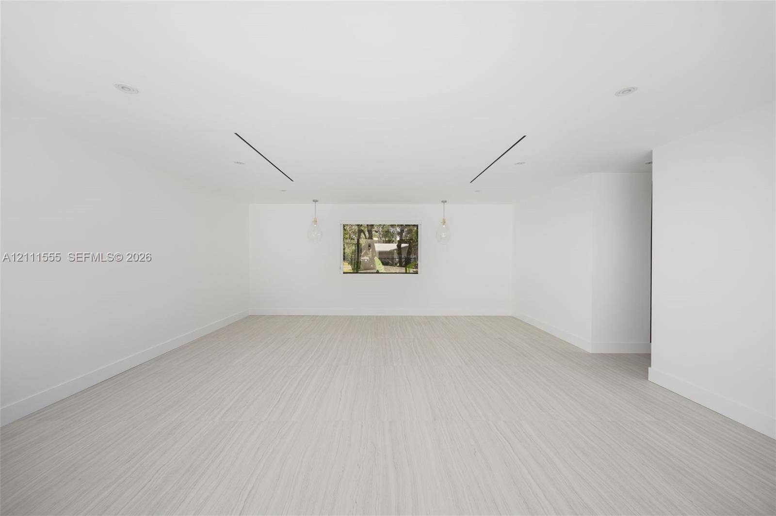 8800 SW 118th Street, Miami, Miami, FL 33176 Neutral interior space featuring wood-finish flooring, recessed lighting, linear architectural ceiling accents, and dual pendant light fixtures