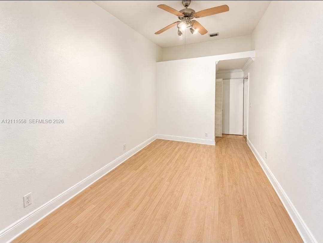 3652 NW 83rd Lane, #3652, Sunrise, Sunrise, FL 33351 Interior space featuring wood-finish flooring, white walls, and a ceiling fan with integrated lighting