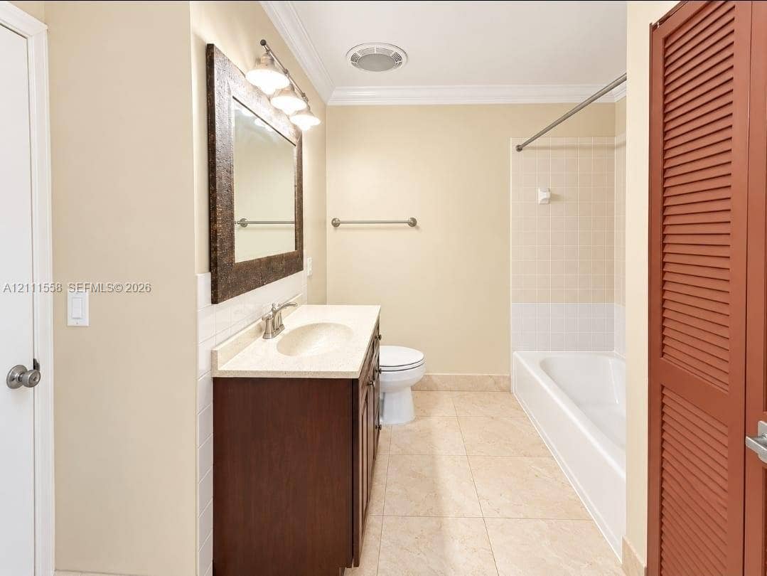 3652 NW 83rd Lane, #3652, Sunrise, Sunrise, FL 33351 Bathroom featuring a vanity with an integrated basin, a dark wood-finish cabinet, a framed mirror, tile flooring, and a shower-tub combination with tiled walls