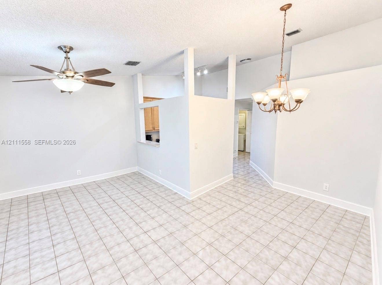 3652 NW 83rd Lane, #3652, Sunrise, Sunrise, FL 33351 Ceramic tile flooring, vaulted ceilings, multi-arm metal chandelier, and a ceiling fan with integrated light fixture