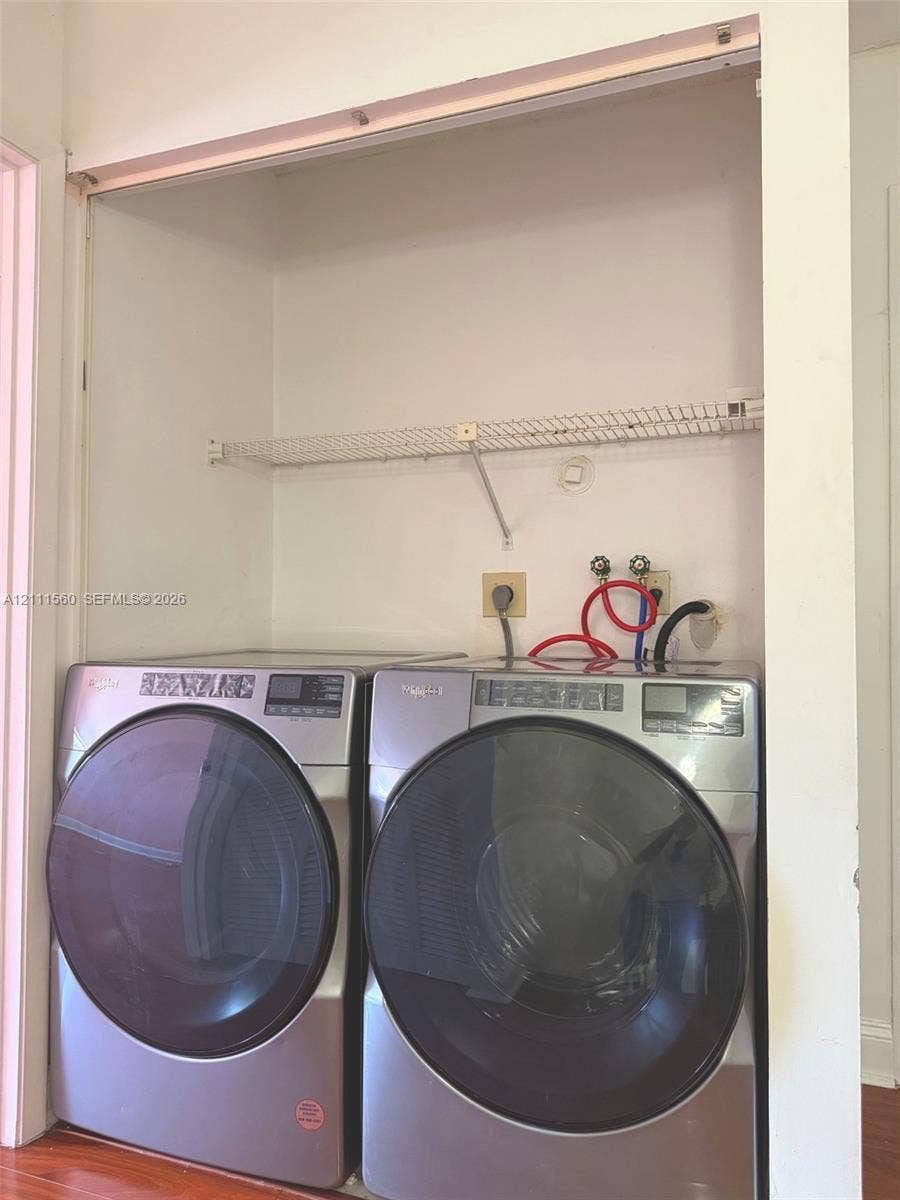 3539 W Inverrary Boulevard W, #1, Lauderhill, Lauderhill, FL 33319 Laundry alcove featuring stainless steel front-loading laundry appliances and a built-in wire shelving unit