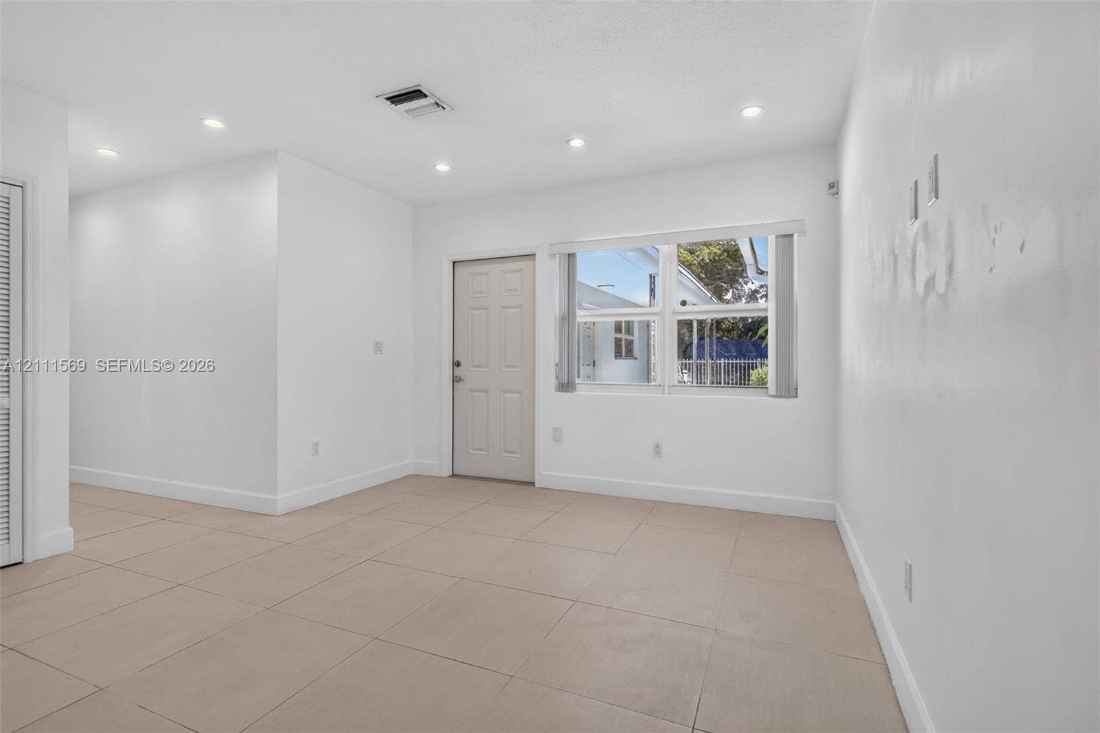12800 NE 11th Avenue, #4, North Miami, North Miami, FL 33161 Neutral-toned tile flooring, recessed ceiling lighting, and a multi-pane window with vertical blinds