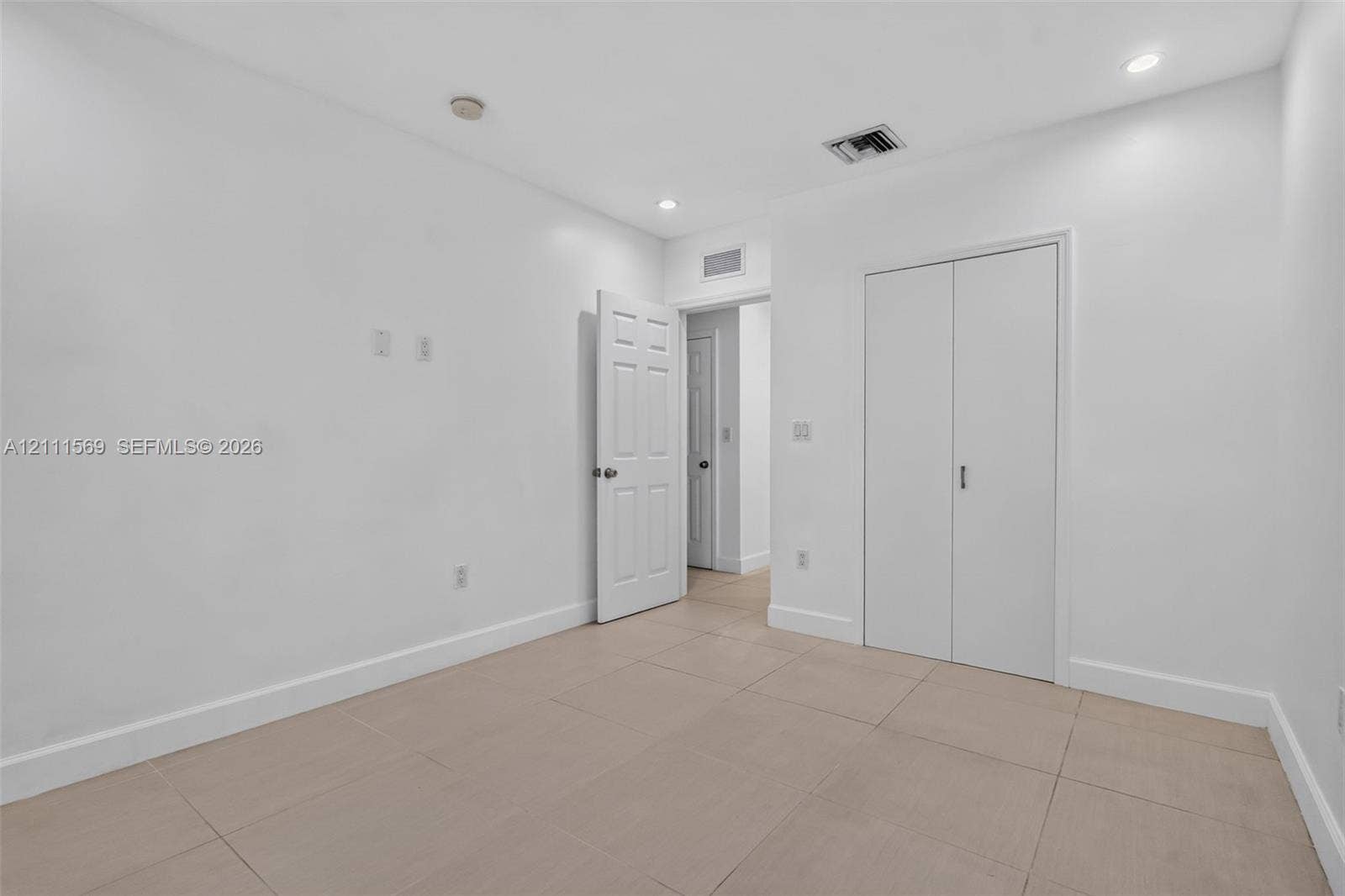 12800 NE 11th Avenue, #4, North Miami, North Miami, FL 33161 Interior space featuring large-format ceramic tile flooring, recessed lighting, and a closet with double-panel doors