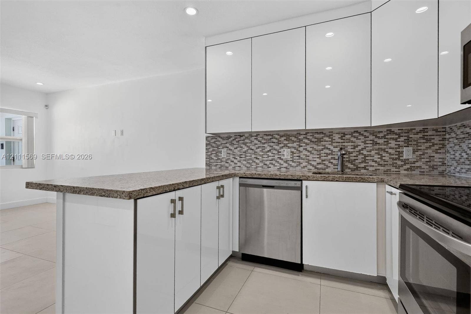 12800 NE 11th Avenue, #4, North Miami, North Miami, FL 33161 Kitchen featuring white high-gloss cabinetry, stone-finish countertops, stainless steel appliances, mosaic tile backsplash, and recessed lighting