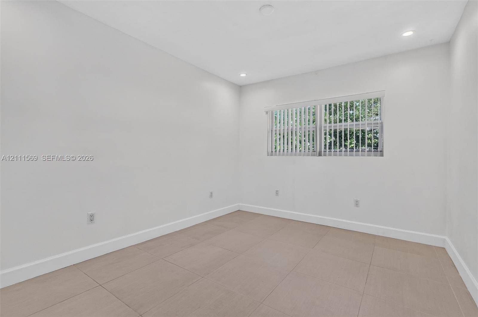 12800 NE 11th Avenue, #4, North Miami, North Miami, FL 33161 Neutral-toned tile flooring, recessed ceiling lighting, and large-format horizontal window with vertical blinds