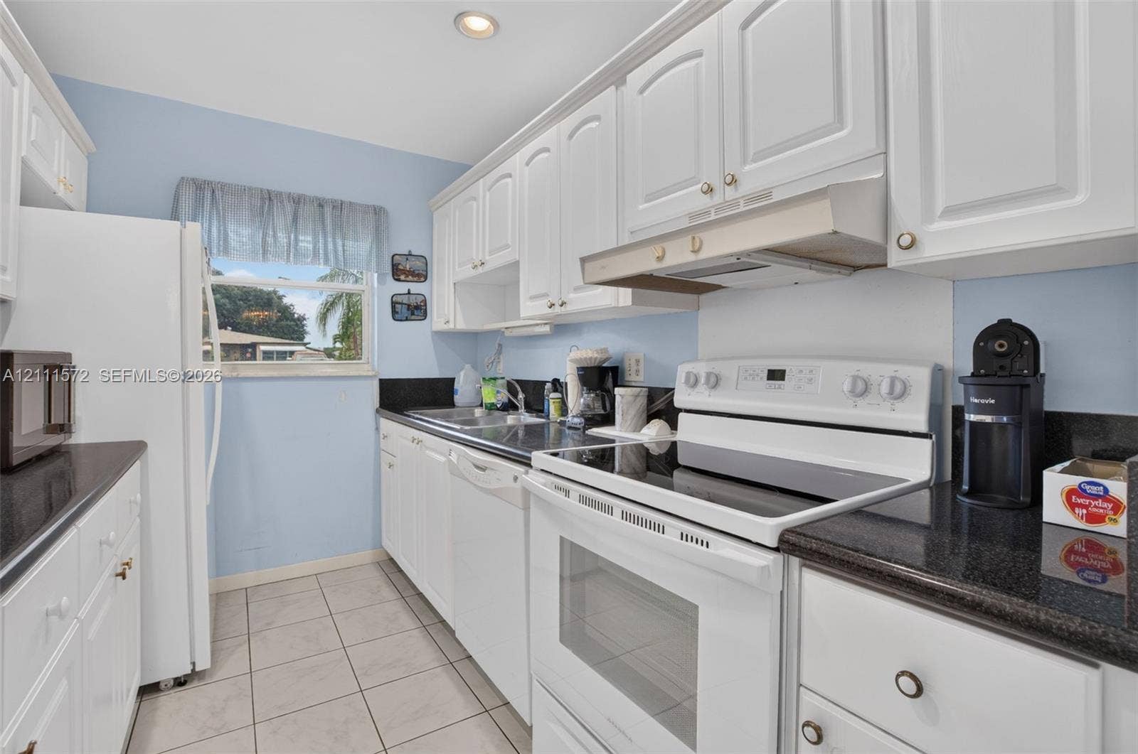 Kitchen featuring white cabinetry, stone countertops, and recessed lighting