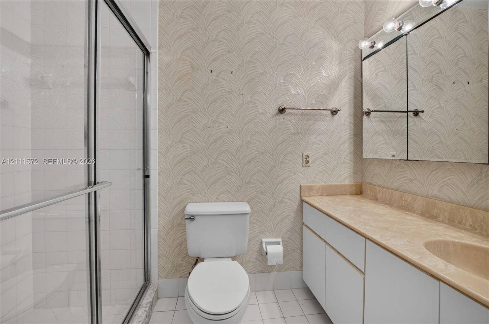 Bathroom featuring a walk-in shower stall with a glass enclosure