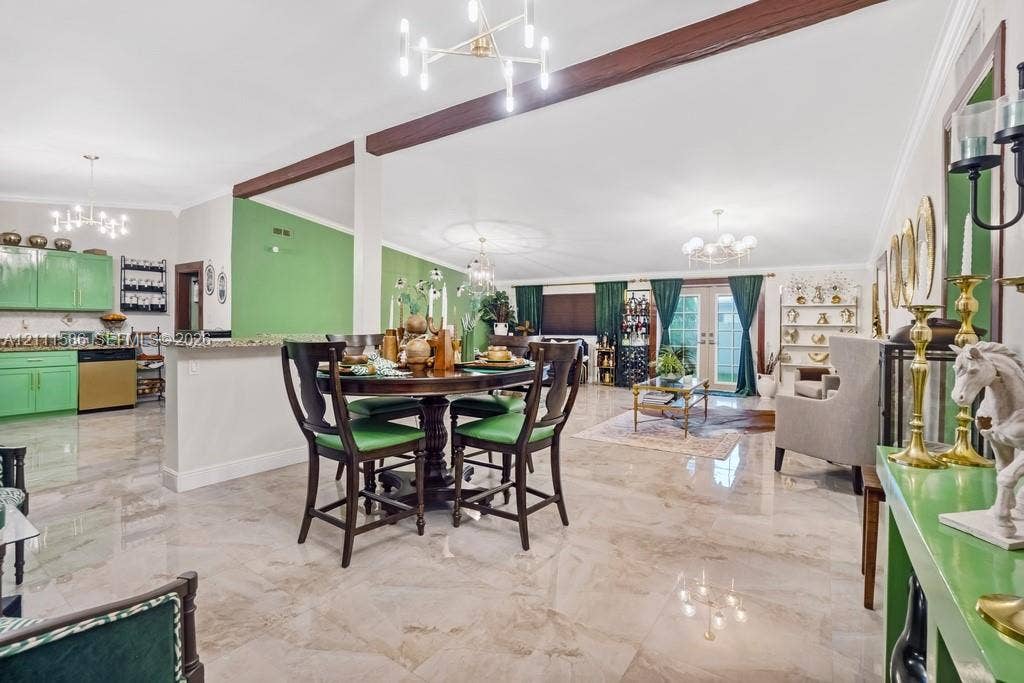 20431 NE 14th Court, Miami, FL 33179 Open-concept interior featuring large-format tile flooring, exposed wood ceiling beams, a multi-arm modern chandelier, and glass-paned double doors