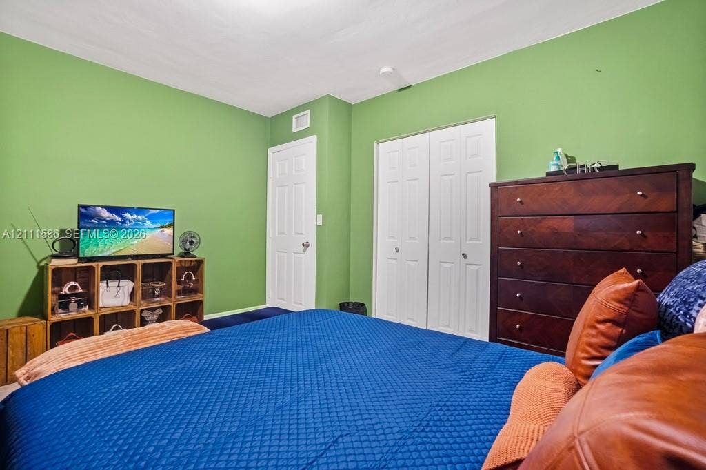 20431 NE 14th Court, Miami, FL 33179 Interior space featuring white six-panel doors and a double-door reach-in closet
