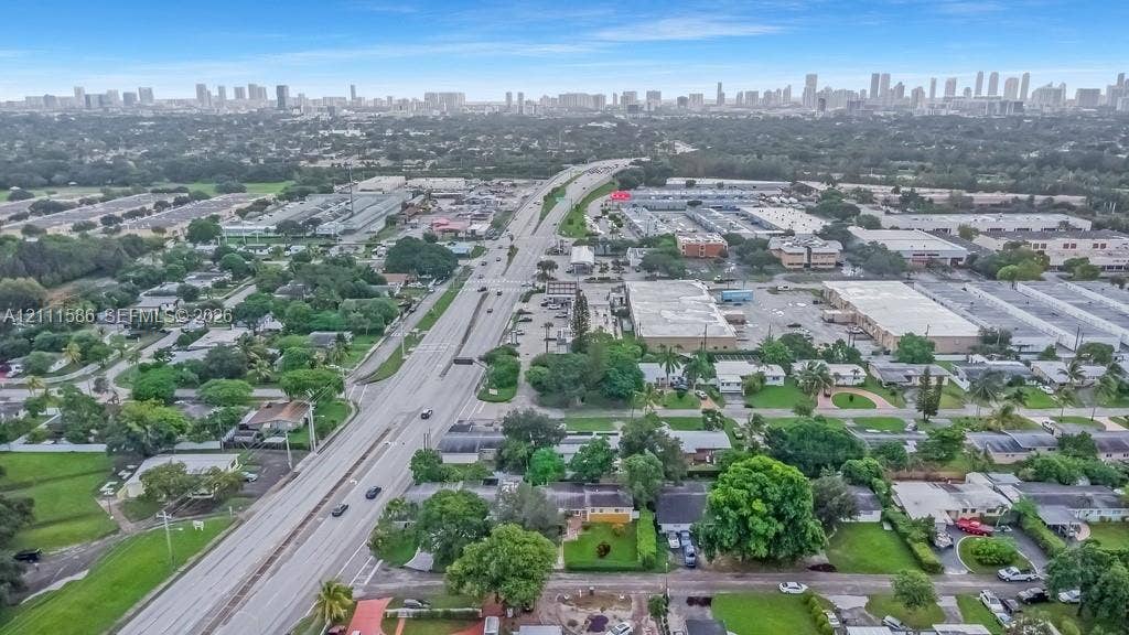 20431 NE 14th Court, Miami, FL 33179 Aerial perspective showcasing urban skyline backdrops, mature tree canopy, and access to local thoroughfares
