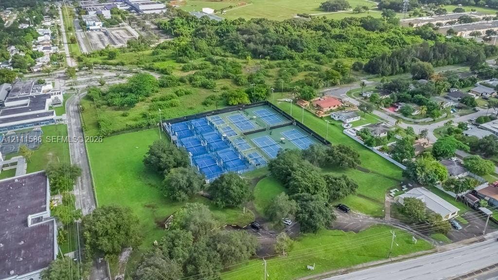 20431 NE 14th Court, Miami, FL 33179 Multi-court tennis facility featuring fenced perimeters, high-mast sports lighting, and manicured green space