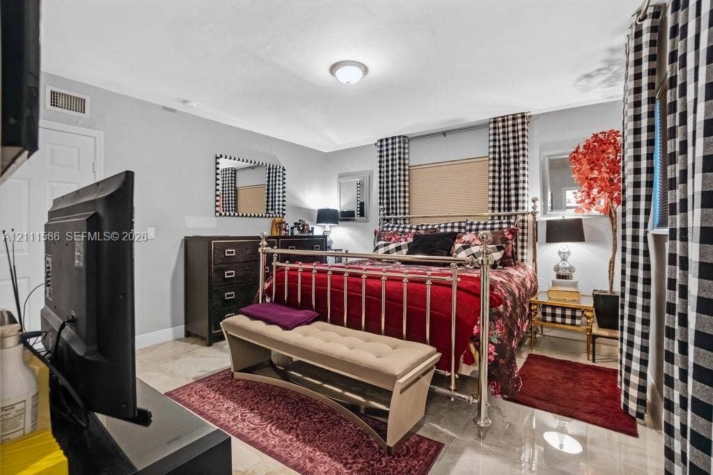 20431 NE 14th Court, Miami, FL 33179 Neutral-toned interior space featuring light-colored stone flooring and a central ceiling-mounted light fixture