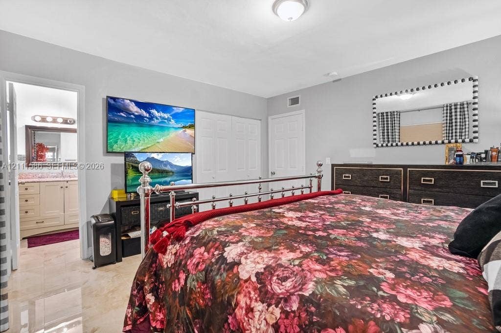 20431 NE 14th Court, Miami, FL 33179 Neutral wall tones, high-gloss tile flooring, and multi-panel closet doors