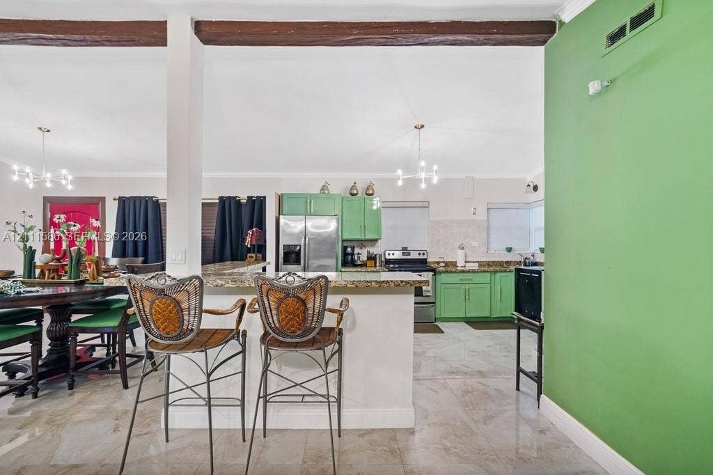 20431 NE 14th Court, Miami, FL 33179 Kitchen featuring cabinetry with matte green finish, stone-surfaced countertops, exposed wood ceiling beams, polished tile flooring, and multiple multi-arm pendant light fixtures
