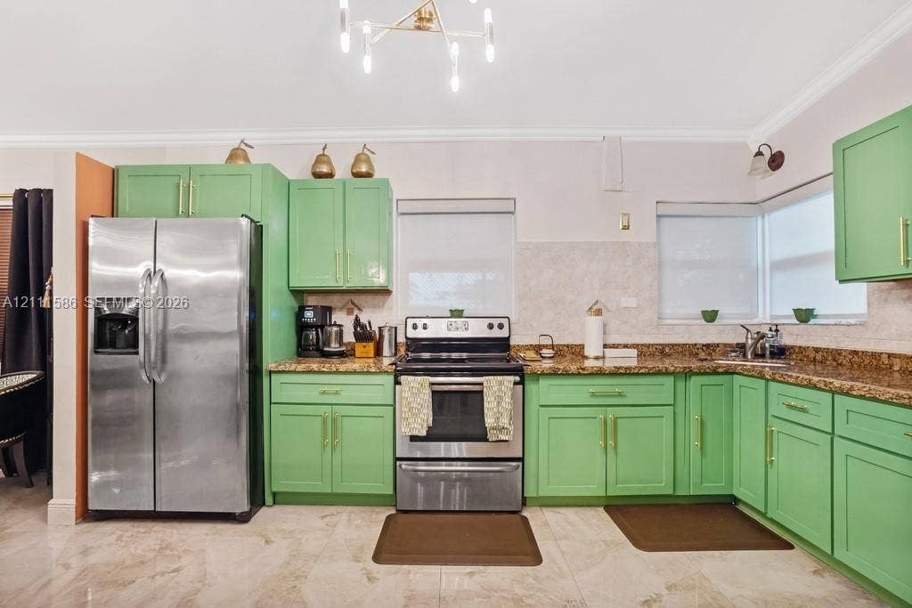 20431 NE 14th Court, Miami, FL 33179 Kitchen featuring green shaker-style cabinetry, gold-tone hardware, stone-finish countertops, tile flooring, and a multi-arm geometric light fixture