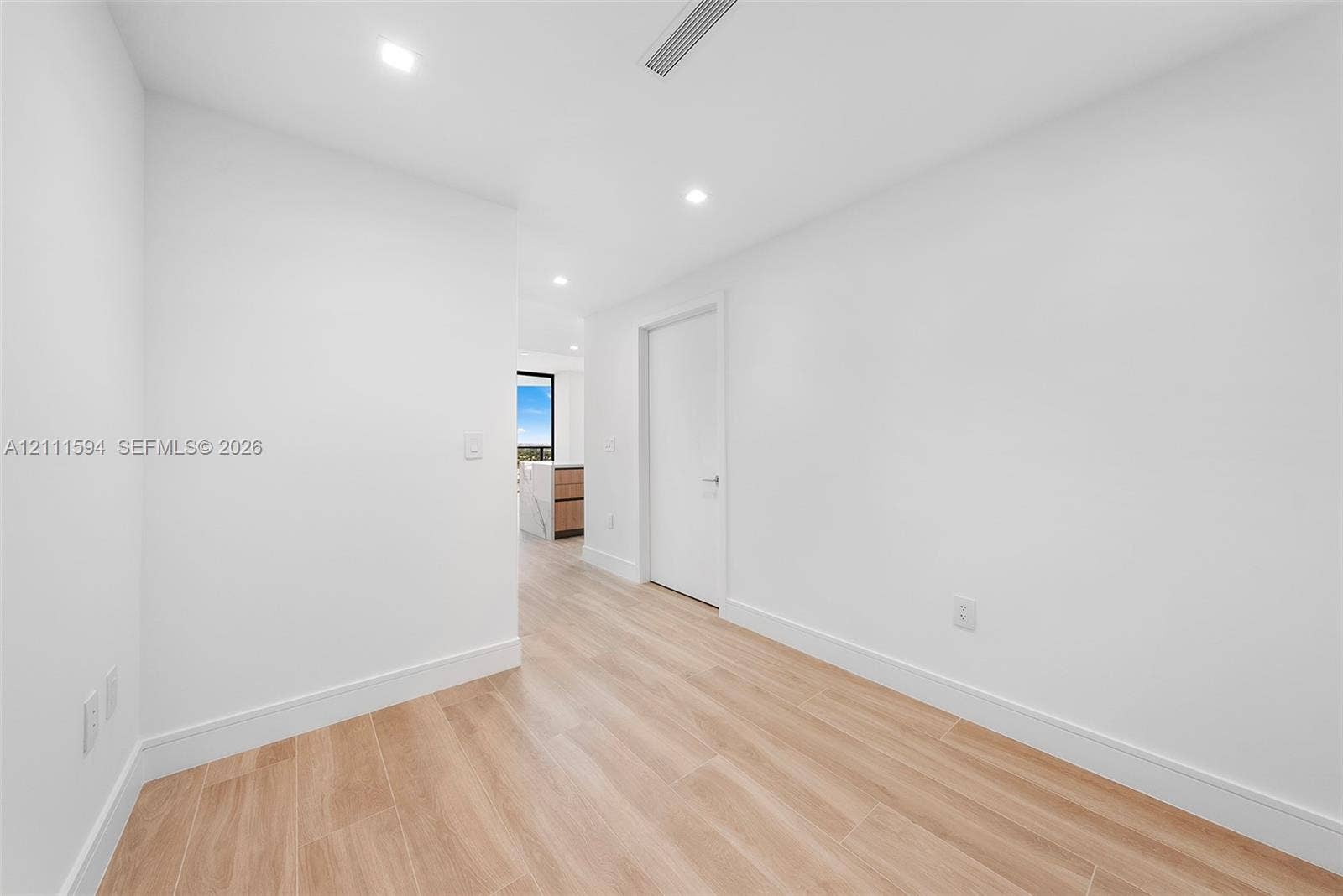 2411 Laguna Circle, #2506, North Miami, FL 33181 Interior space featuring wood-finish flooring, recessed lighting, and crisp white wall finishes