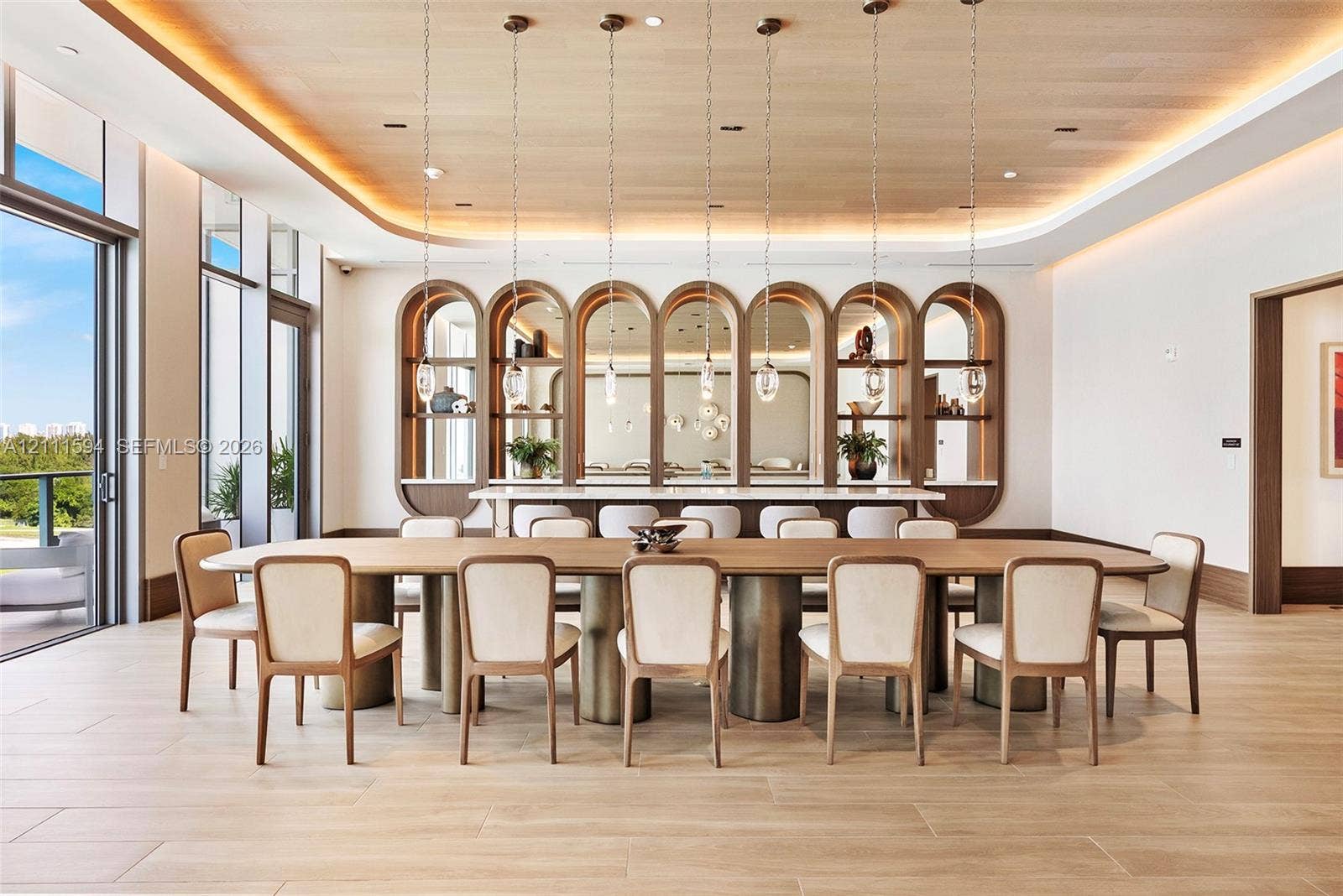 2411 Laguna Circle, #2506, North Miami, FL 33181 Wood-finish tile flooring, recessed ceiling lighting with cove detailing, wood-paneled ceiling, custom arched built-in shelving, and floor-to-ceiling glass wall panels