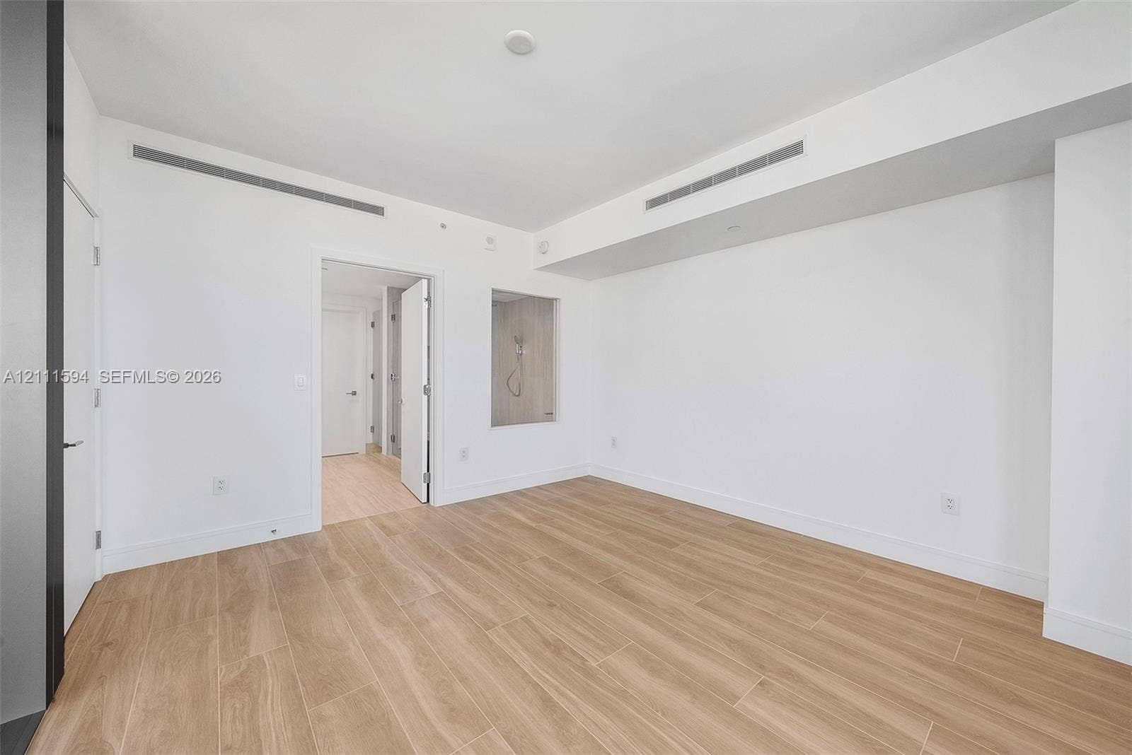 2411 Laguna Circle, #2506, North Miami, FL 33181 Minimalist interior featuring wood-finish flooring, recessed ceiling lighting, and a square wall niche