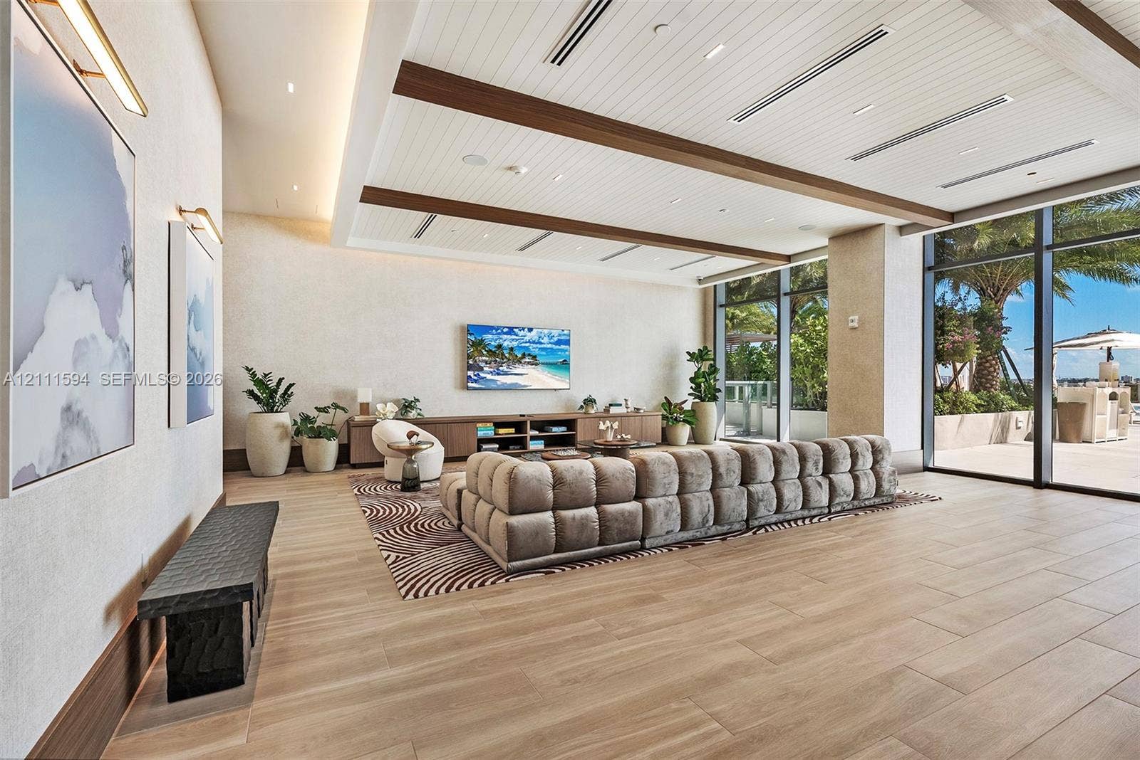 2411 Laguna Circle, #2506, North Miami, FL 33181 Expansive room featuring a wood-plank ceiling with decorative beams, floor-to-ceiling glass windows, recessed lighting, and large-format wood-finish flooring