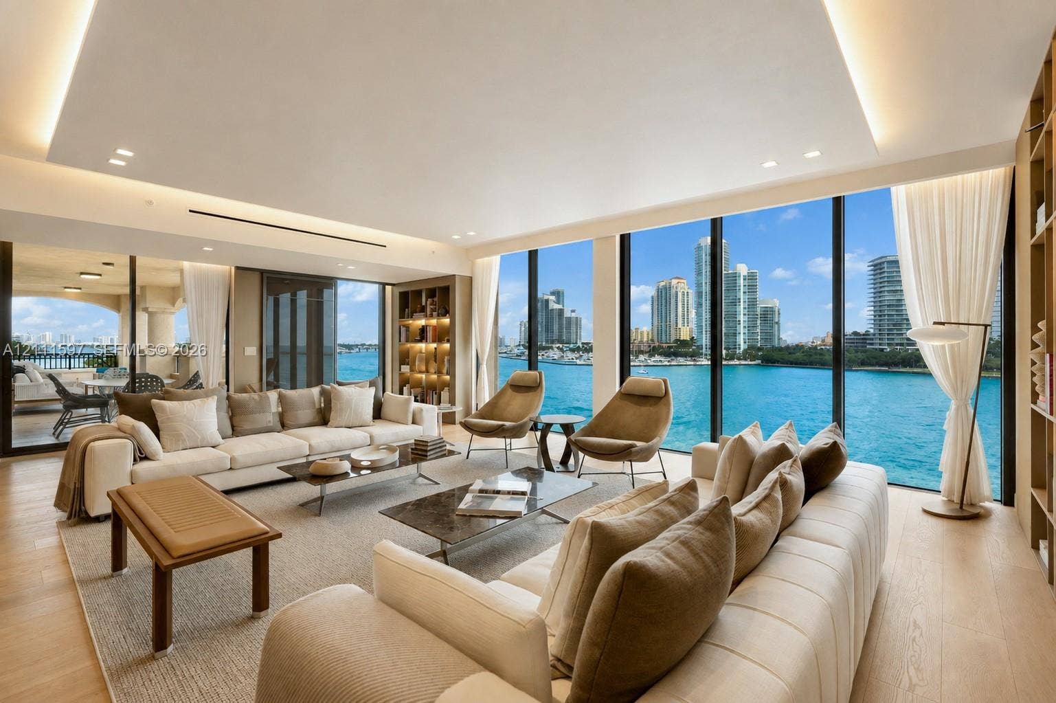 Floor-to-ceiling glass windows, recessed cove lighting, built-in floor-to-ceiling shelving, and wood-finish flooring