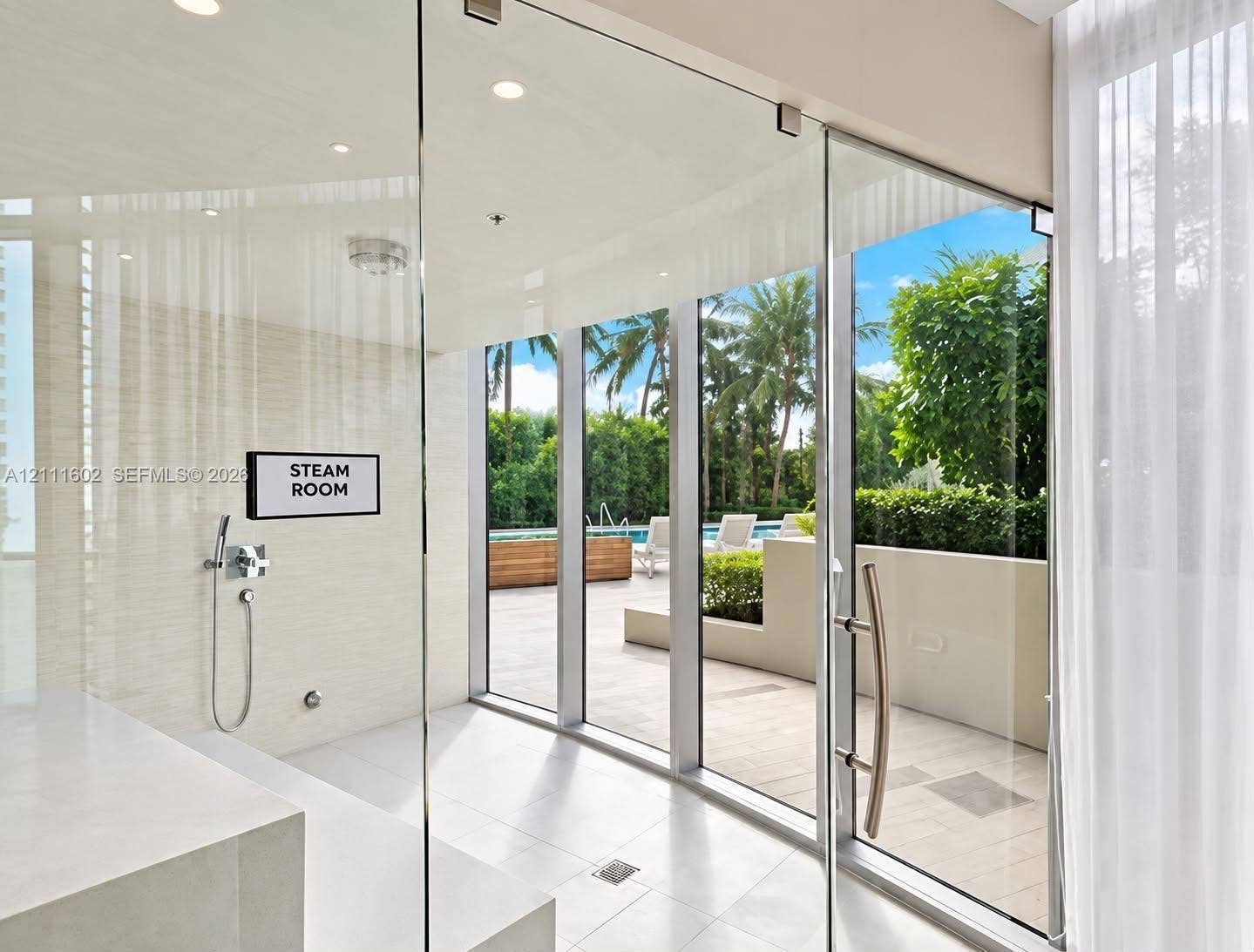 Steam room featuring full-height glass walls, wall-mounted handheld shower fixture, recessed ceiling lighting, and porcelain tile flooring