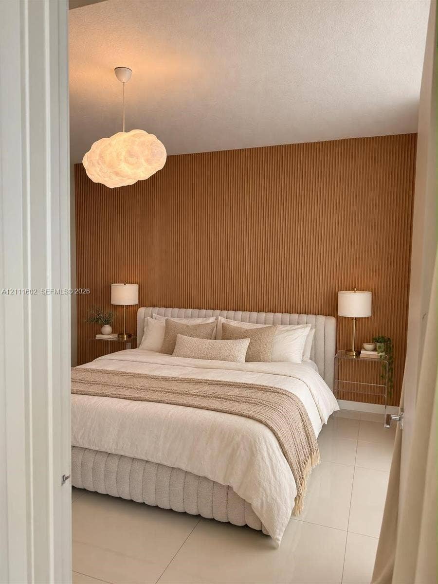 Vertical wood-slat accent wall, tile flooring, and sculptural cloud-shaped pendant lighting