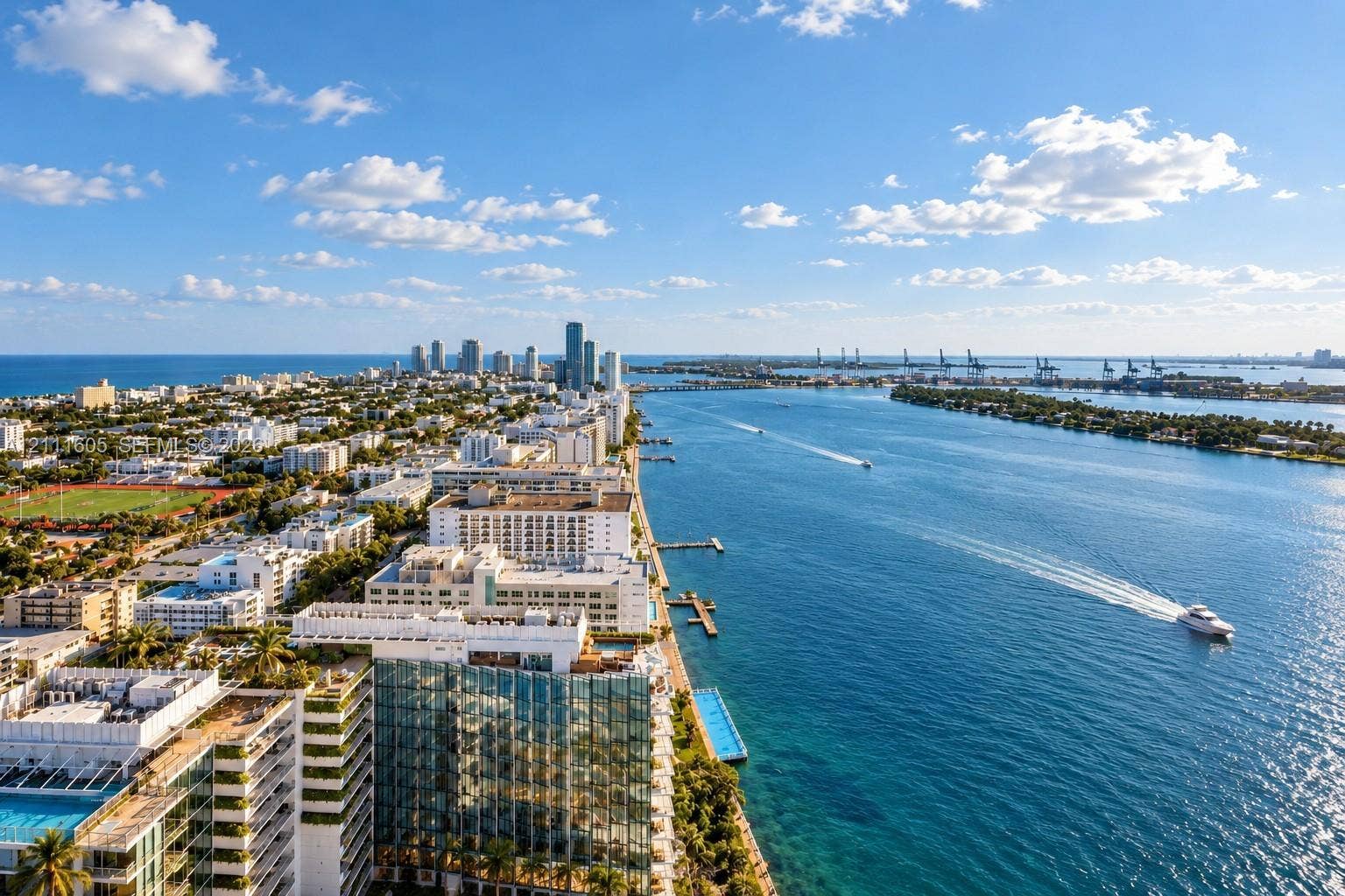 Aerial perspective showcasing expansive water frontage, direct ocean access, urban skyline, and regional coastal landscape