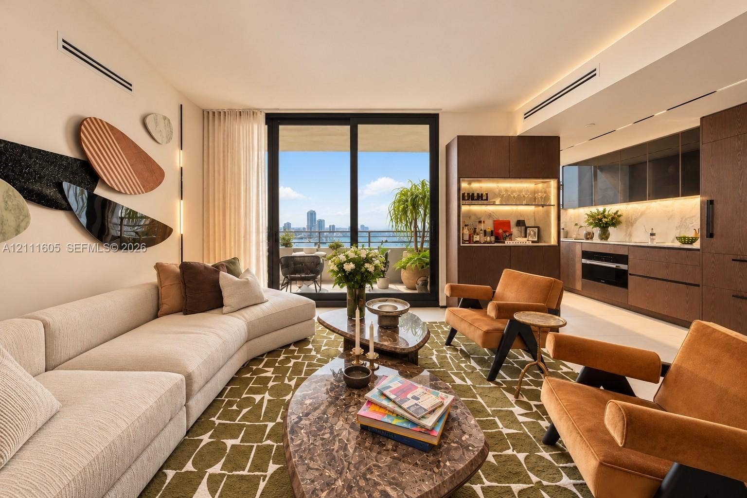 Open-concept living space featuring floor-to-ceiling sliding glass doors, built-in dark wood cabinetry with integrated lighting, stone-surface backsplash, and recessed ceiling lighting