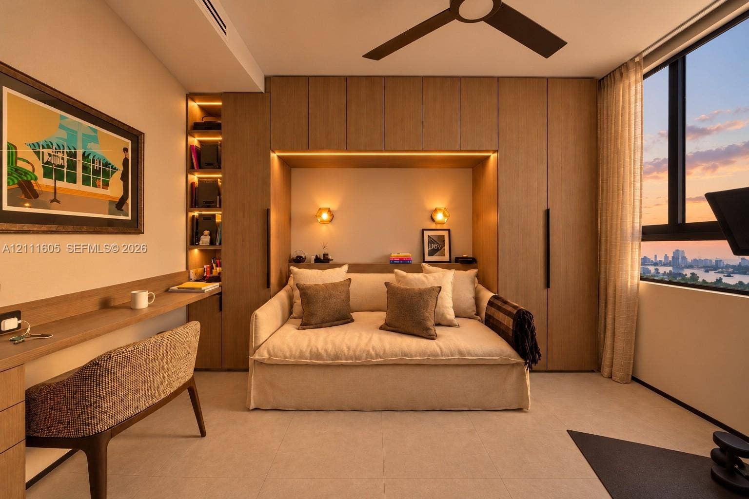 Custom wood-finish cabinetry featuring integrated shelving, recessed accent lighting, floor-to-ceiling wardrobe storage, a built-in workspace, and large-format windows with expansive exterior scenery