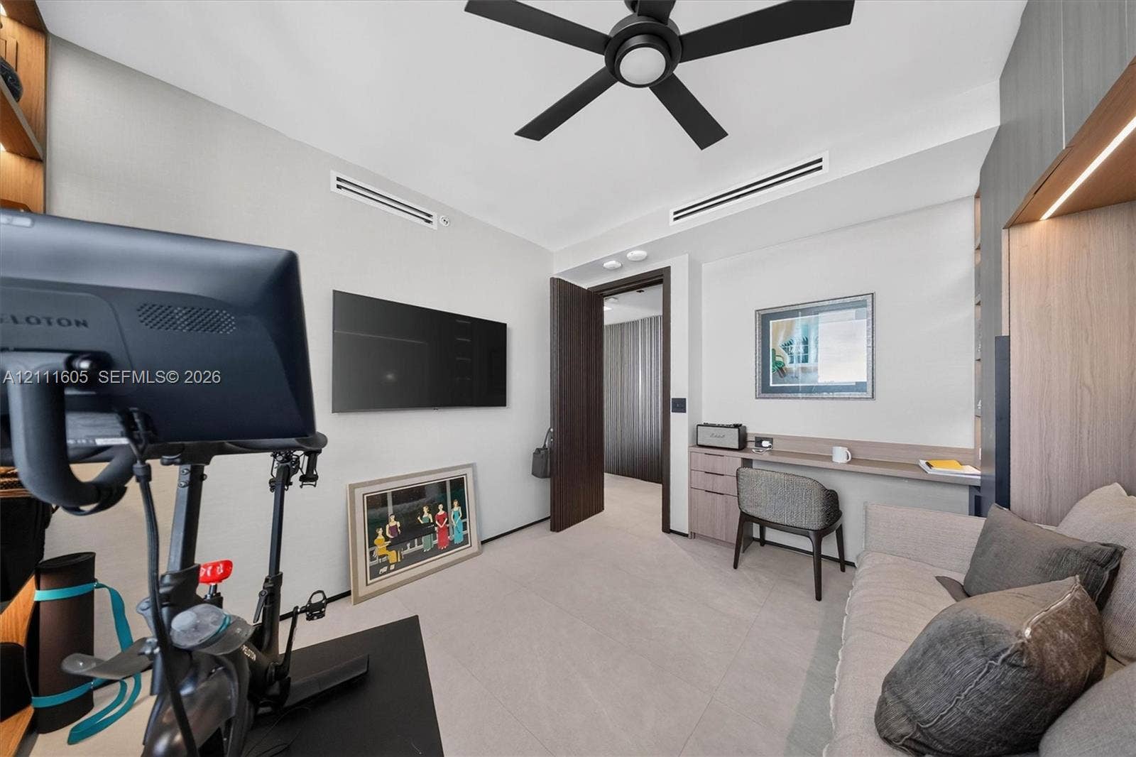 Neutral-toned flooring, built-in desk with integrated storage cabinetry, recessed ceiling lighting, and matte black ceiling fan