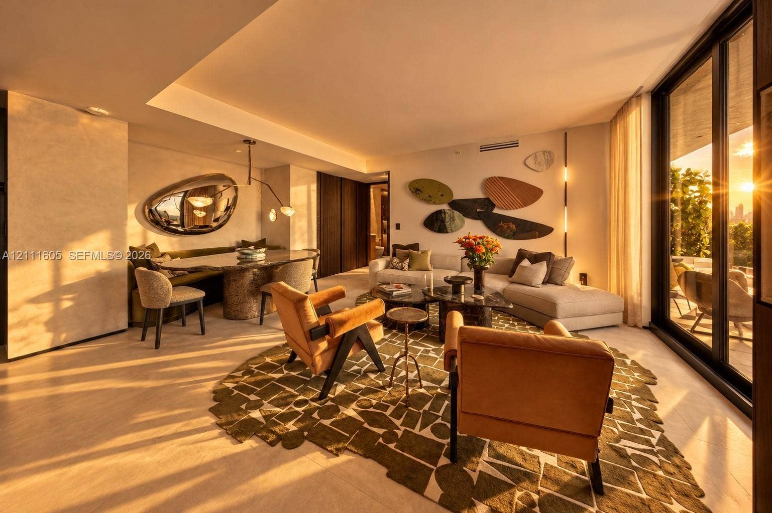 Open-concept interior featuring floor-to-ceiling sliding glass doors, neutral stone flooring, recessed ceiling lighting, and dark wood-finished cabinetry