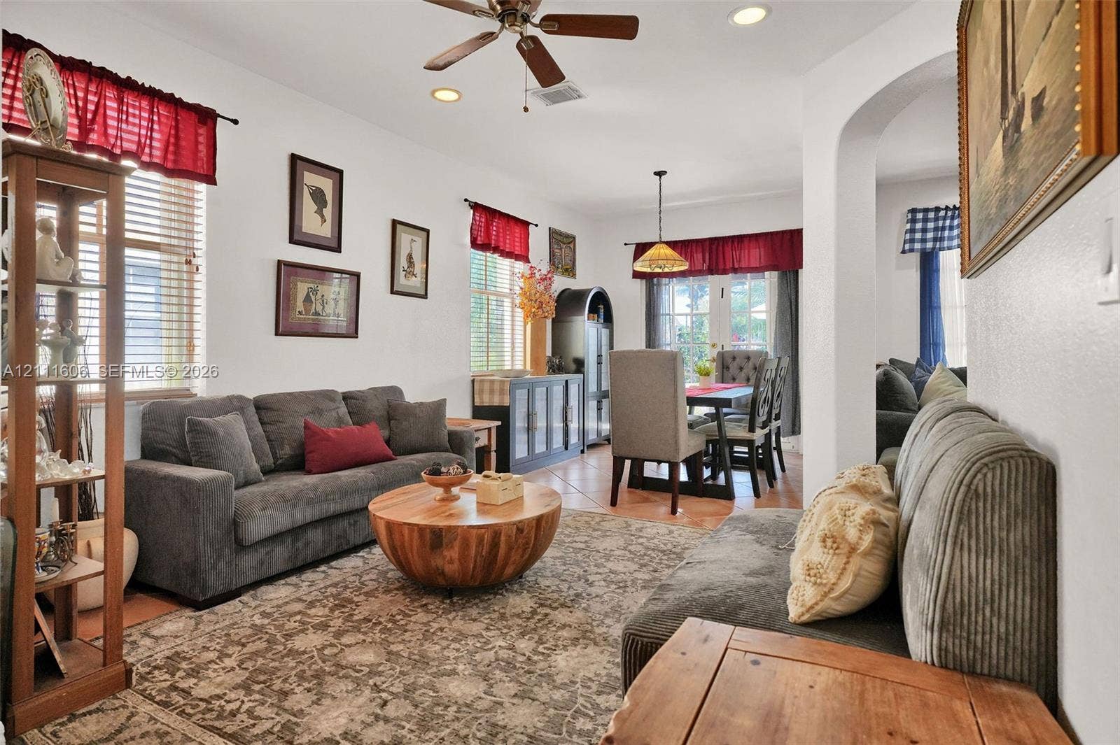 Open-concept interior featuring recessed lighting, a ceiling fan, arched doorways, and tile flooring