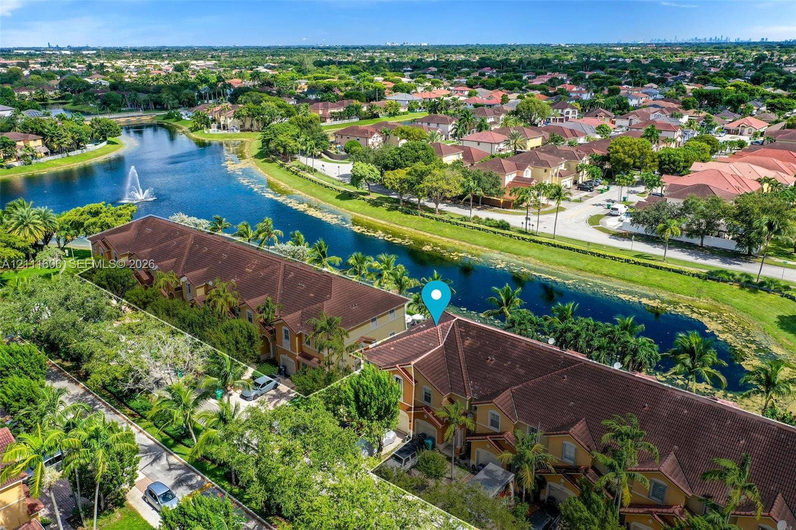 Aerial perspective featuring multi-story residential buildings with shingle-style rooflines, waterfront placement, and mature landscaping