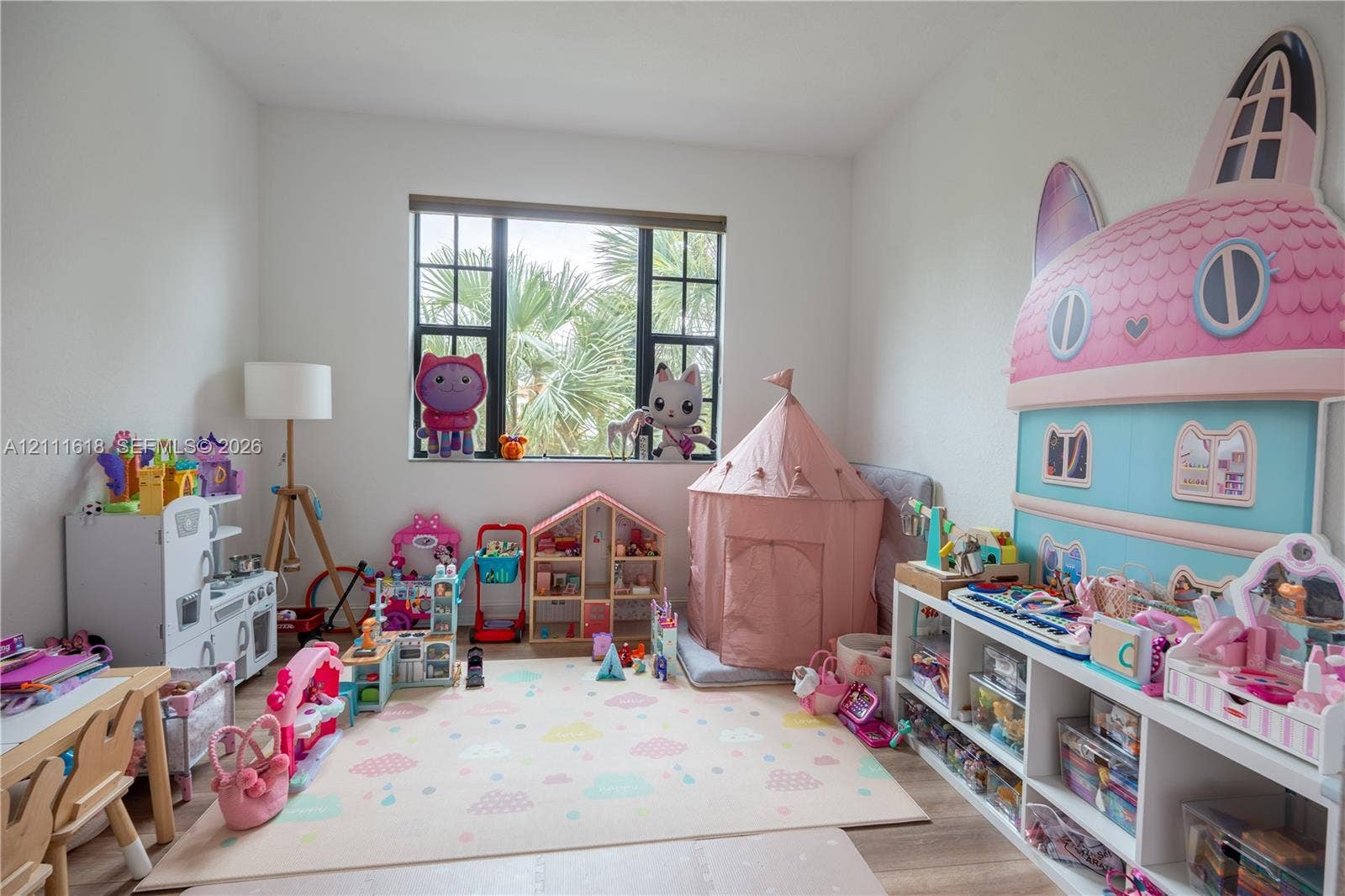 1423 SW 115th Avenue, #NA, Pembroke Pines, Pembroke Pines, FL 33025 Neutral-toned interior space featuring wood-finish flooring and a multi-pane window with dark-toned frames