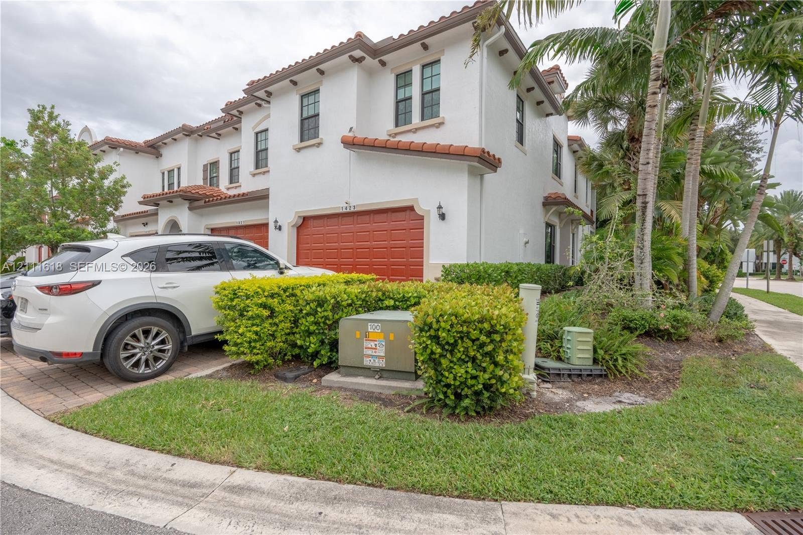 1423 SW 115th Avenue, #NA, Pembroke Pines, Pembroke Pines, FL 33025 Stucco exterior featuring red-tiled roof accents, paver driveway, and attached two-car garage