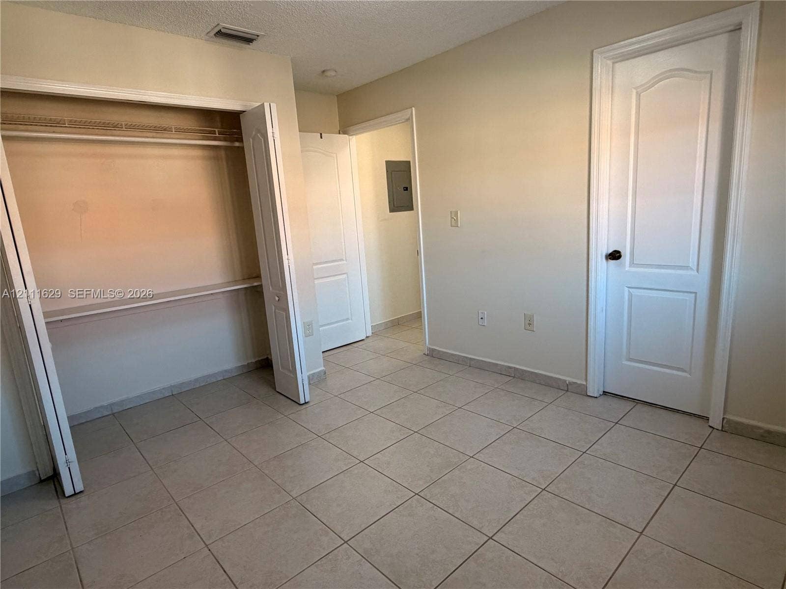 Ceramic tile flooring, paneled interior doors, and built-in closet shelving