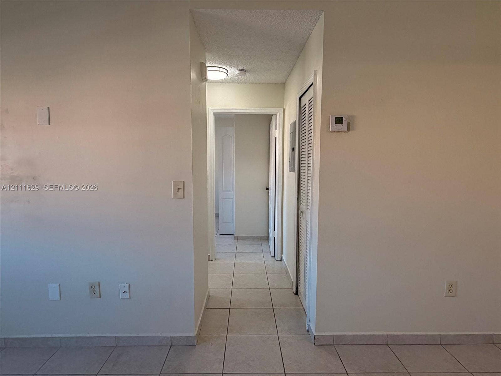 Ceramic tile flooring, louvered closet door, and recessed ceiling lighting