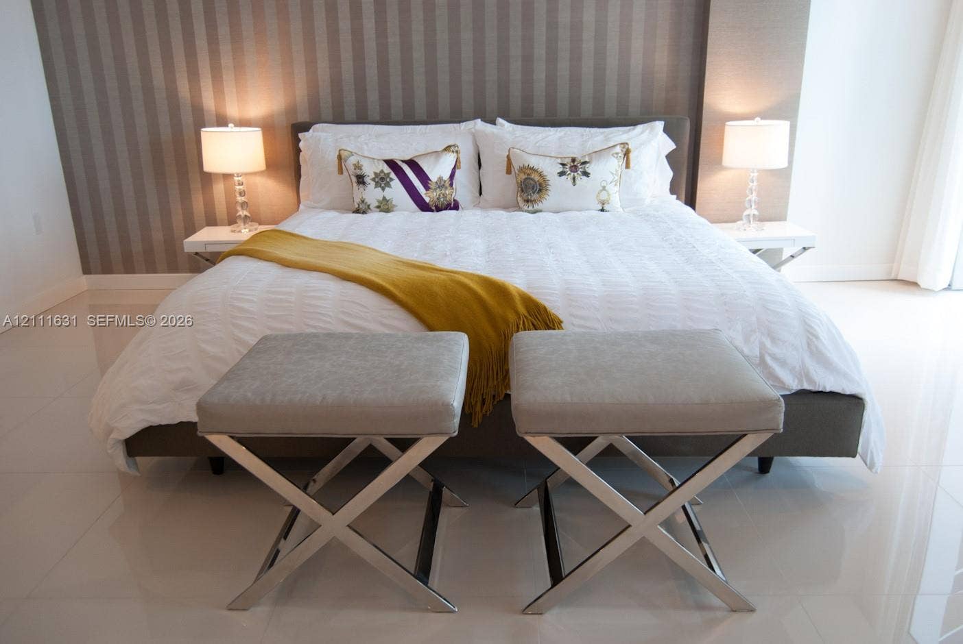 Neutral-toned striped wallpaper, large-format tile flooring, and two wall-mounted floating shelves