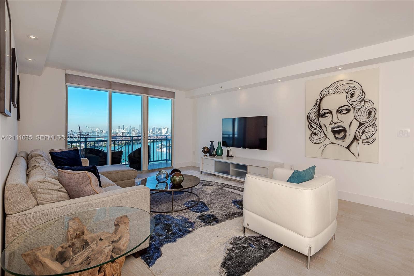 90 Alton Road, #2410, Miami Beach, FL 33139 Open-concept room featuring floor-to-ceiling windows, light-toned wood-finish flooring, recessed lighting, and a private balcony