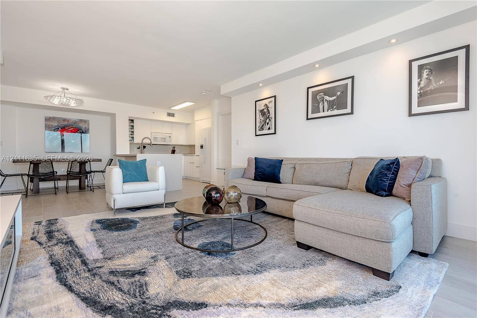 90 Alton Road, #2410, Miami Beach, FL 33139 Open-concept interior featuring recessed ceiling lighting, light-toned wood-finish flooring, a kitchen breakfast bar, and neutral walls