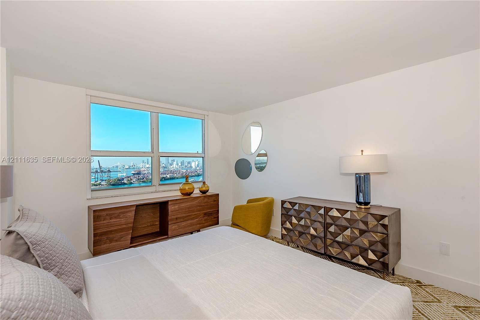 90 Alton Road, #2410, Miami Beach, FL 33139 Large-pane window with a water and city skyline backdrop
