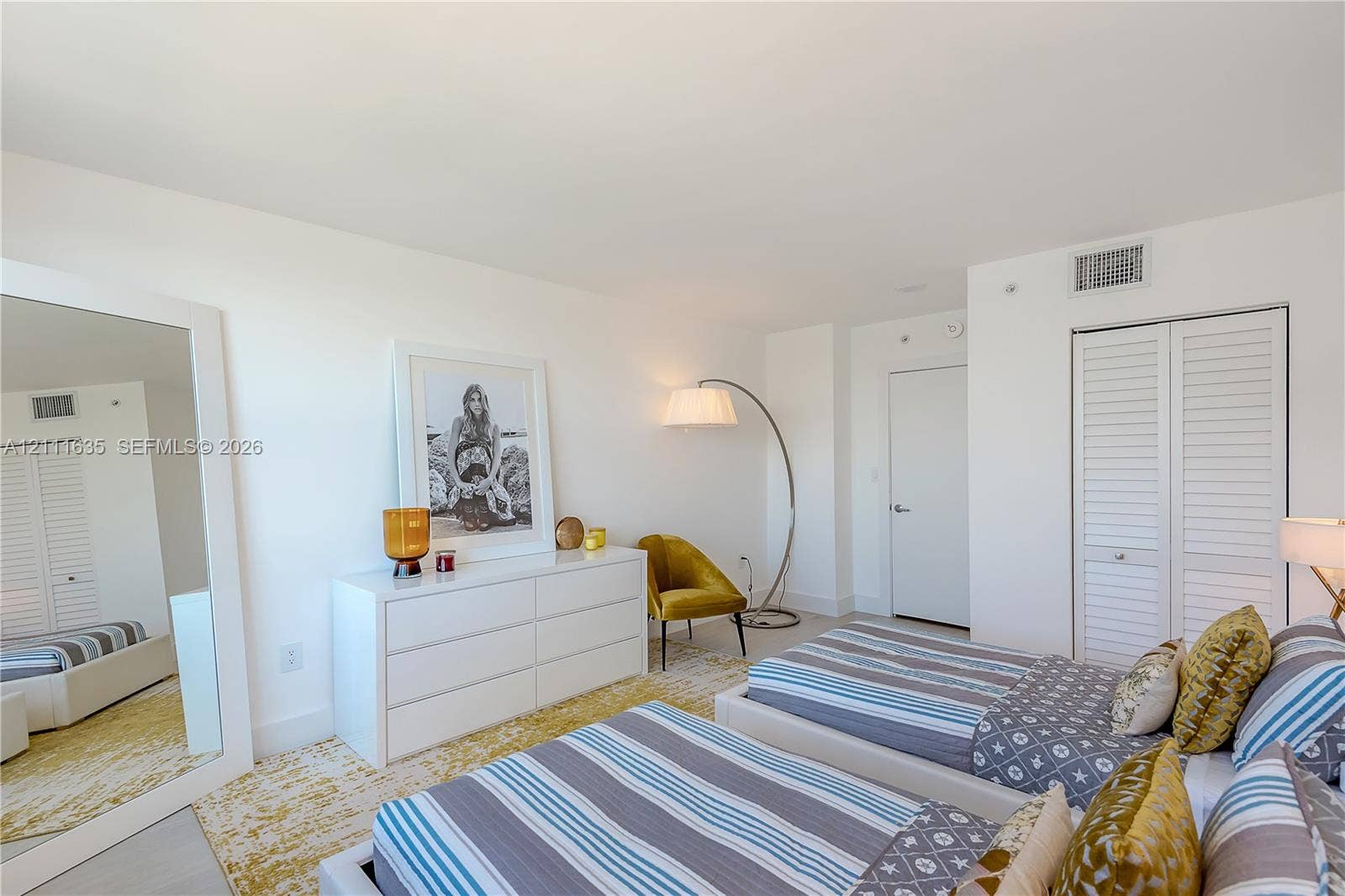 90 Alton Road, #2410, Miami Beach, FL 33139 Neutral interior space featuring white walls, smooth-finish ceiling, and double-door closet with louvered panels