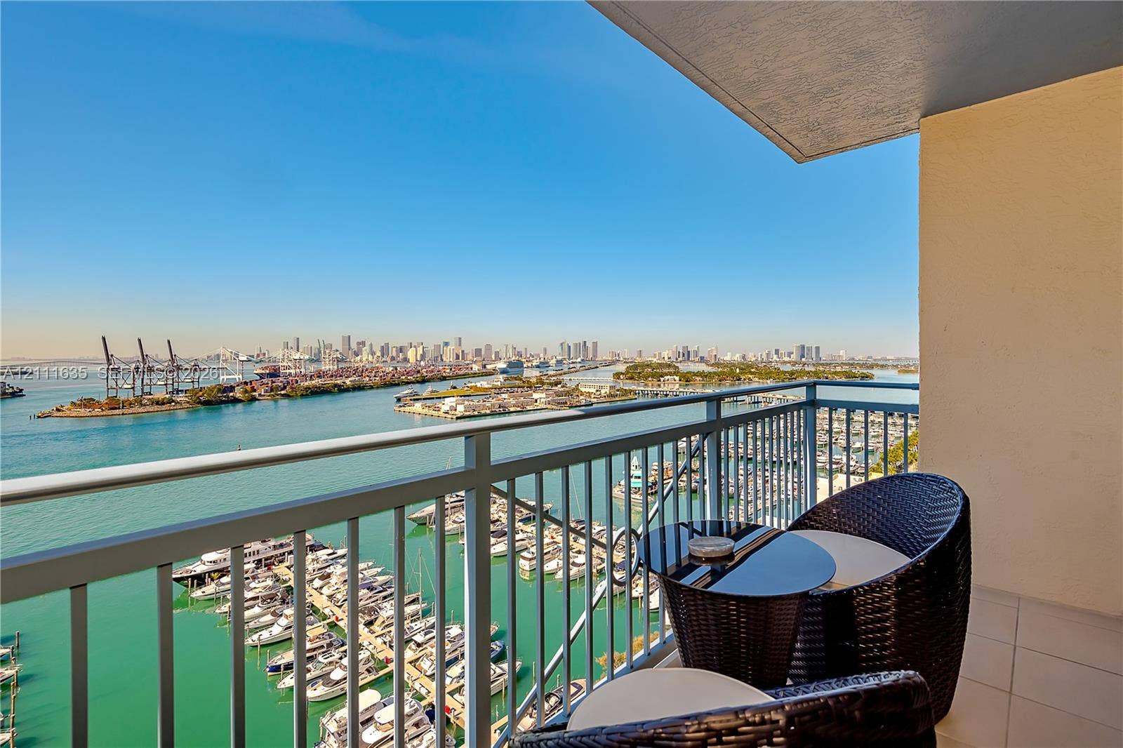 90 Alton Road, #2410, Miami Beach, FL 33139 Private balcony with a metal railing, featuring large-format tile flooring and an overhead ceiling