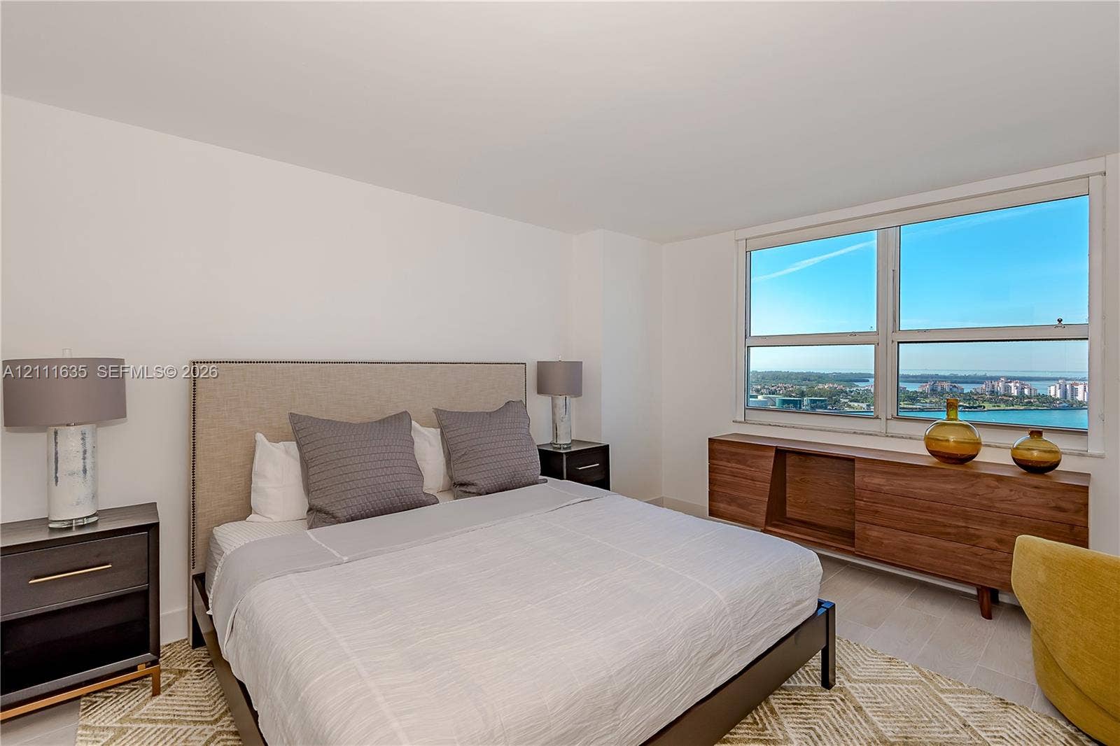 90 Alton Road, #2410, Miami Beach, FL 33139 Bedroom featuring large format windows, wood-finish flooring, and neutral wall paint