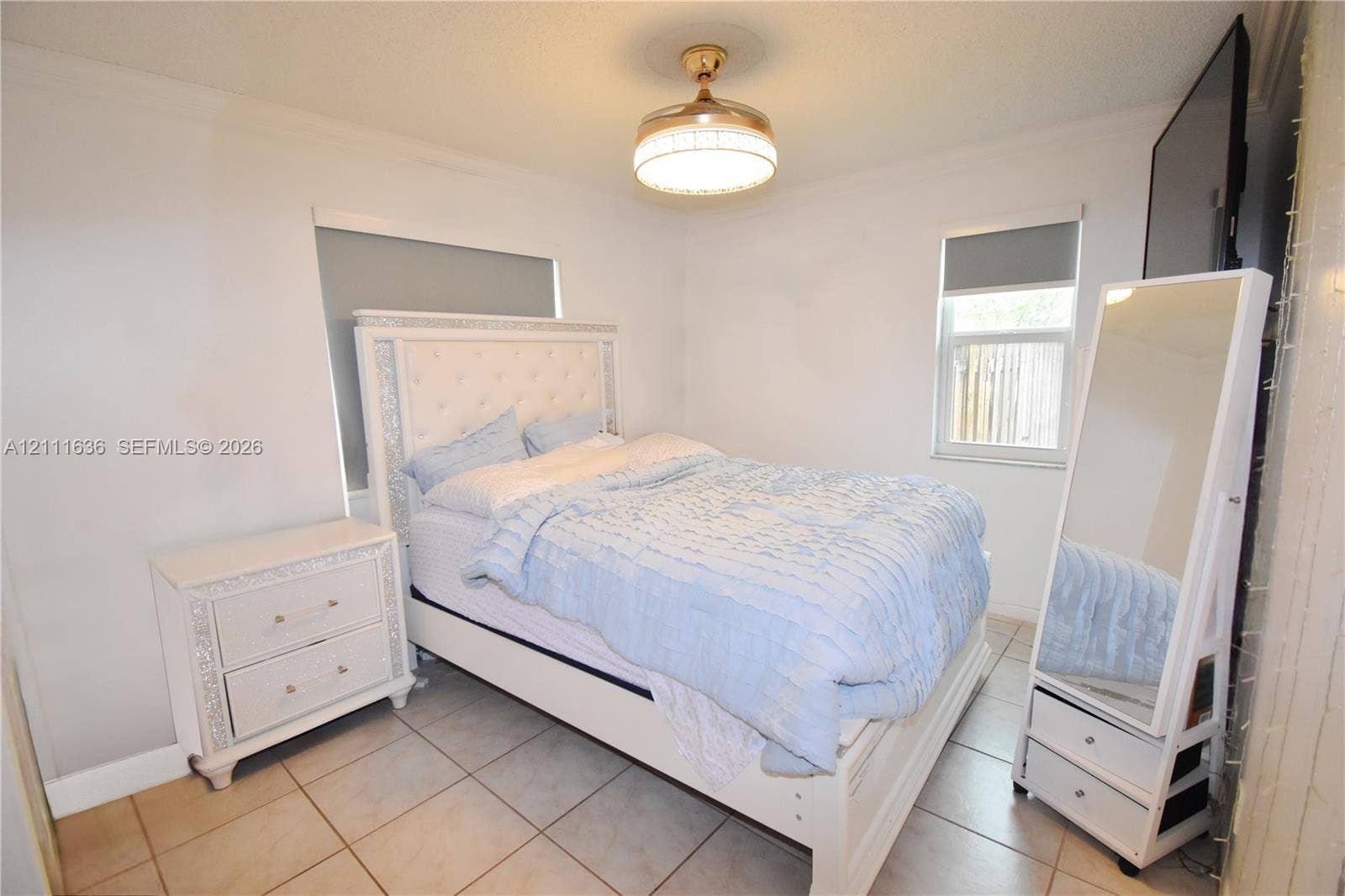 Tile flooring and ceiling-mounted drum light fixture with an integrated fan