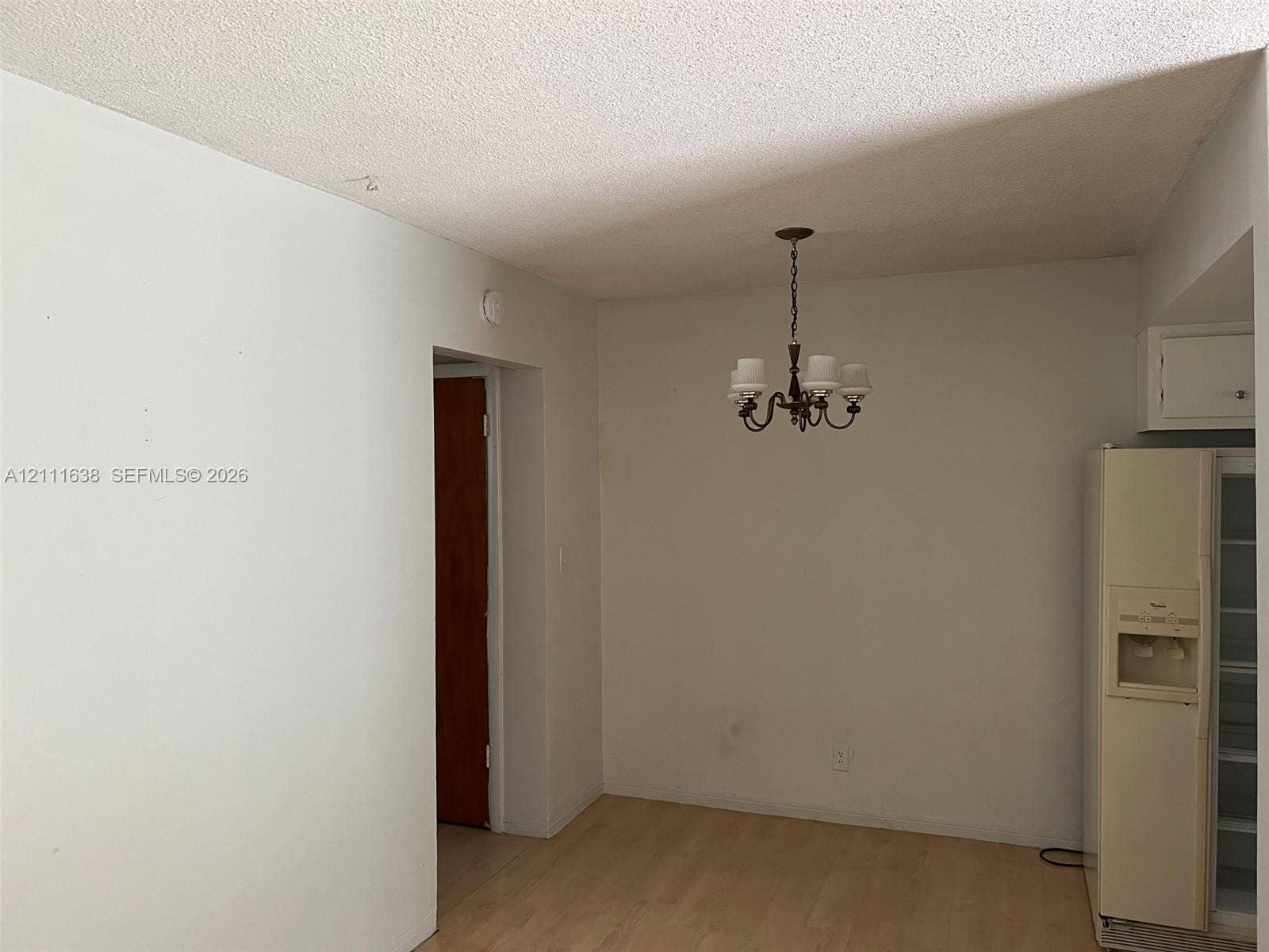 4841 SW 45th Avenue, #2, Hollywood, Hollywood, FL 33314 Interior space featuring wood-finish flooring, a multi-arm chandelier, and built-in upper cabinetry