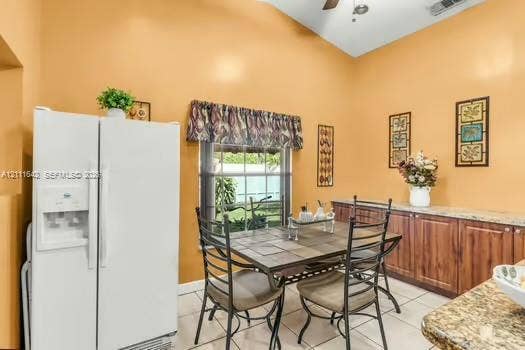 12801 SW 248th Terrace, Homestead, FL 33032 Vaulted ceiling featuring a central light fixture and built-in cabinetry with stone-surface counters and wood-finish doors