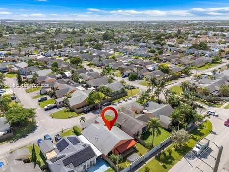 12801 SW 248th Terrace, Homestead, FL 33032 Aerial perspective featuring a single-story residence with a pitched roof, integrated covered patio area, and mature perimeter landscaping