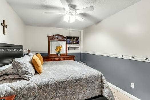 12801 SW 248th Terrace, Homestead, FL 33032 Neutral wall color scheme with chair rail molding, ceiling-mounted light fixture with fan, and wall-mounted storage hooks